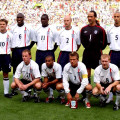 Team wearing England 2002 shirt